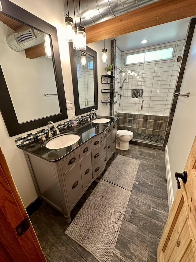 full bathroom featuring double vanity, a sink, visible vents, and a shower stall
