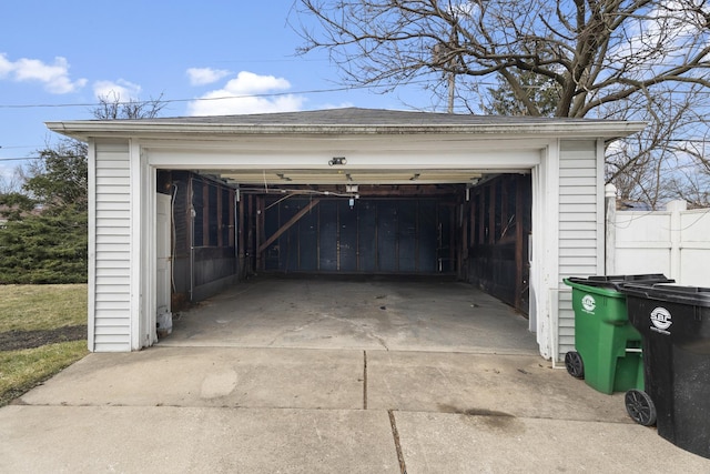 detached garage featuring fence