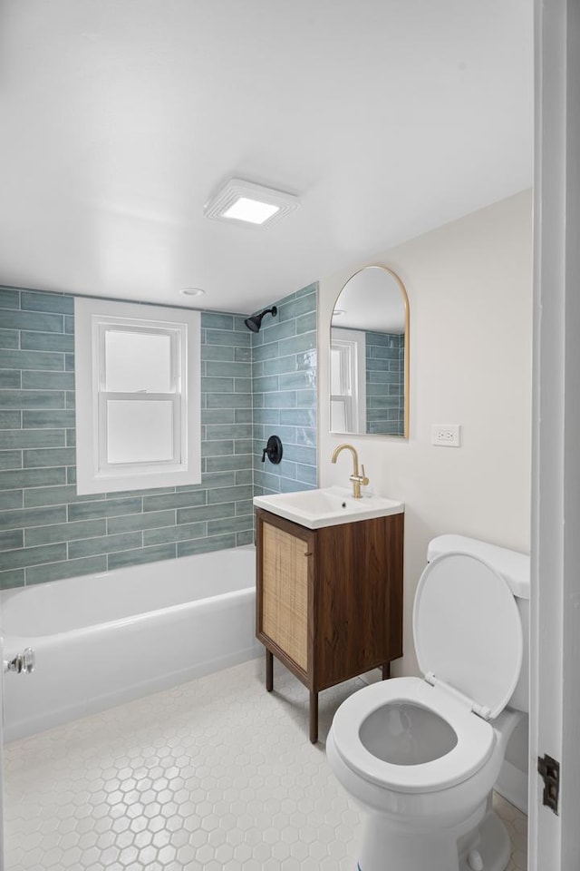 bathroom featuring shower / bathing tub combination, toilet, tile patterned floors, and vanity