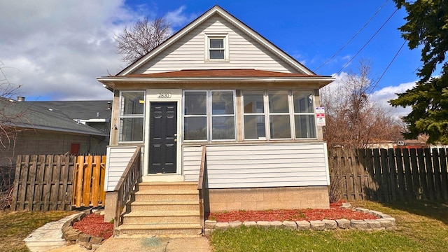 2830 Bernice Rd, Lansing, IL 60438 - bungalow-style house with a sunroom, fence, and entry steps