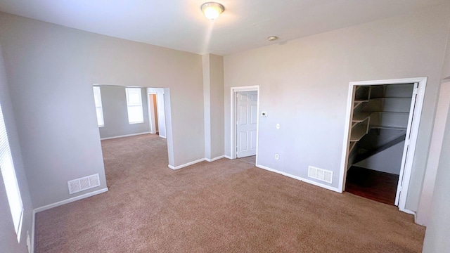 2830 Bernice Rd, Lansing, IL 60438 - unfurnished bedroom with a walk in closet, baseboards, visible vents, and carpet flooring