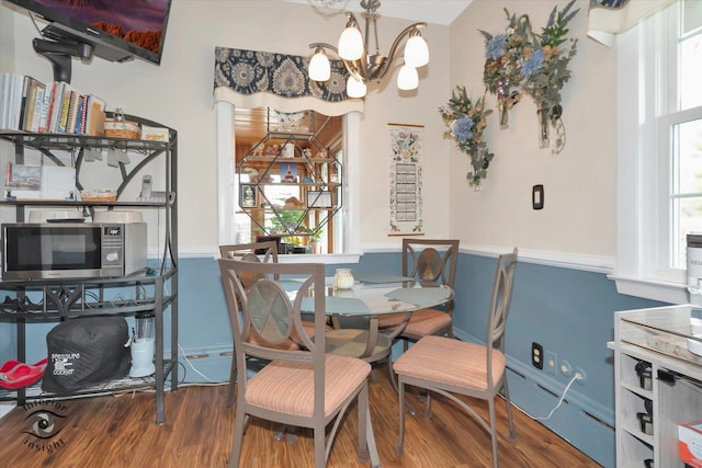 dining room with a chandelier and wood finished floors