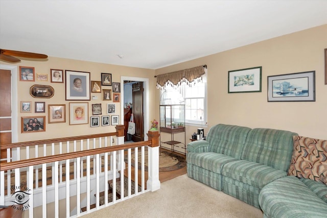 carpeted living room with a ceiling fan