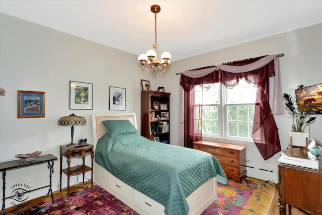 bedroom with a baseboard heating unit and a chandelier