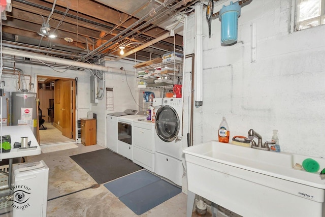 laundry area with washing machine and clothes dryer and gas water heater