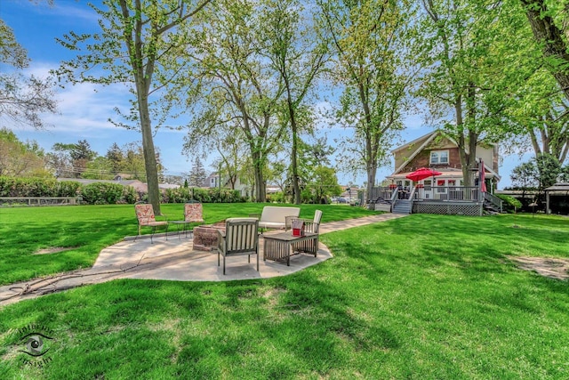 view of green lawn with a deck and a patio area