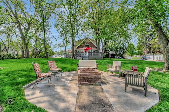 view of patio / terrace featuring an outdoor fire pit and a deck