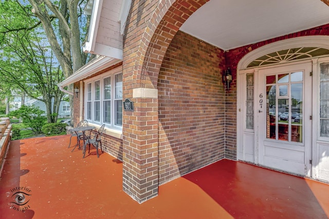 doorway to property featuring brick siding