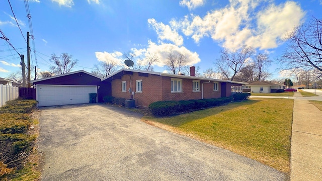 view of front of property featuring fence, a chimney, a garage, a front yard, and driveway