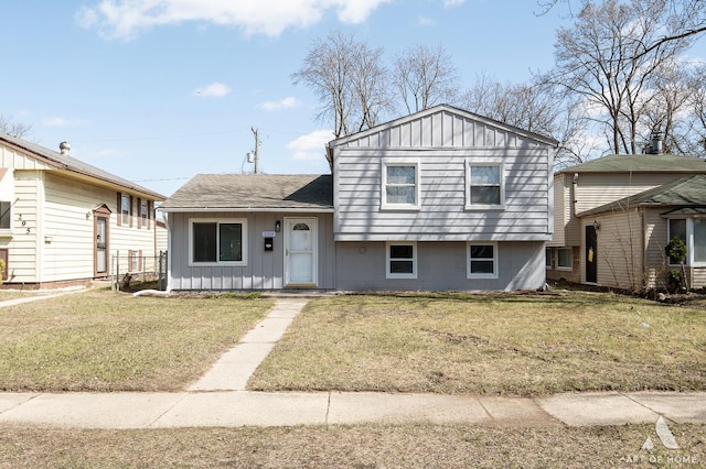 split level home with a front lawn and board and batten siding