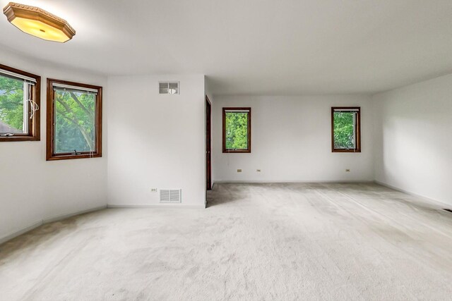 unfurnished room with light carpet and visible vents