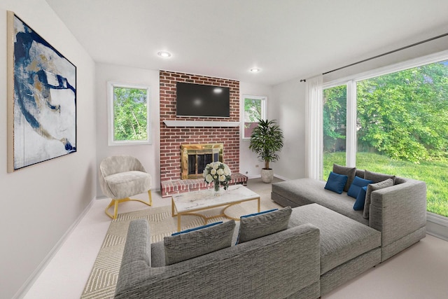 carpeted living area with baseboards, a fireplace, and recessed lighting
