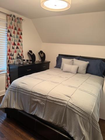 8034 S Clyde Ave, Chicago, IL 60617 - bedroom with dark wood-type flooring and vaulted ceiling