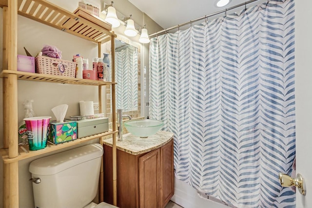 bathroom featuring curtained shower, toilet, and vanity