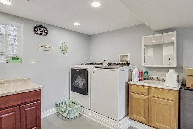 clothes washing area featuring recessed lighting, baseboards, a sink, cabinet space, and washer and dryer