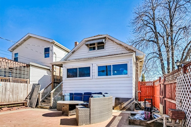 rear view of property featuring a fenced backyard and a chimney