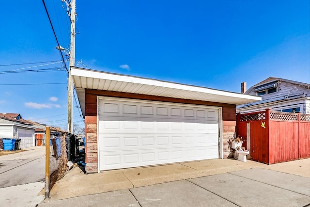 detached garage featuring fence