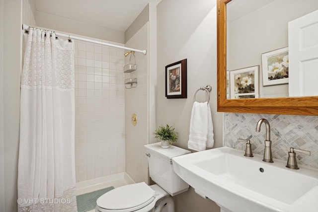 bathroom with a sink, toilet, backsplash, visible vents, and a stall shower
