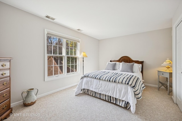 carpeted bedroom with visible vents and baseboards