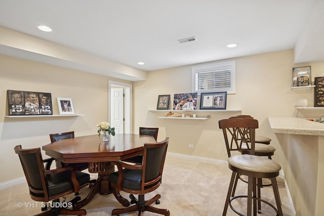 dining area with light colored carpet, a dry bar, baseboards, and recessed lighting