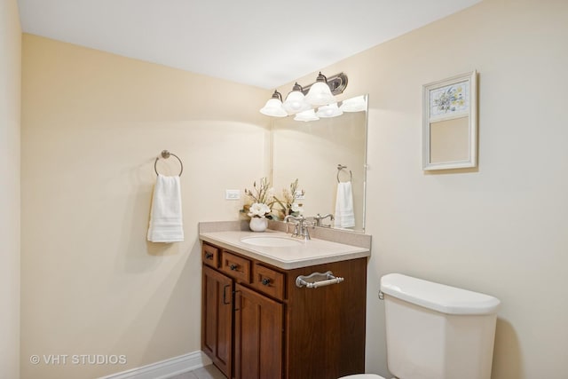 half bathroom with vanity and toilet