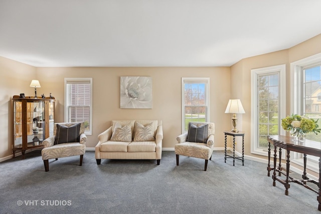 carpeted living room featuring baseboards