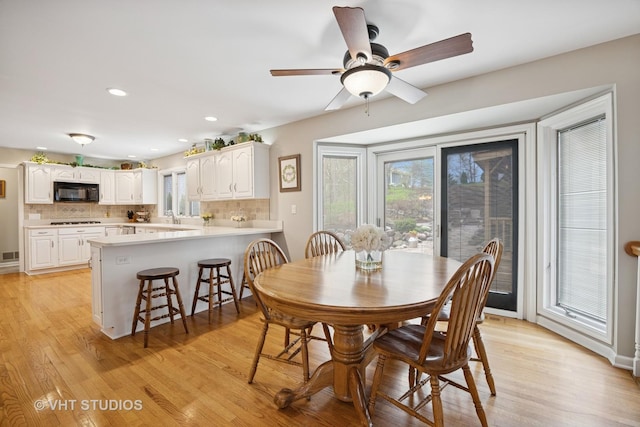 dining area with recessed lighting, ceiling fan, light wood-type flooring, and visible vents