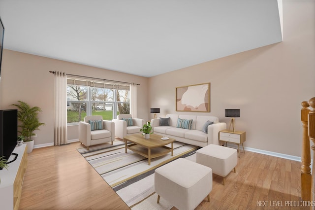 living room with baseboards and wood finished floors