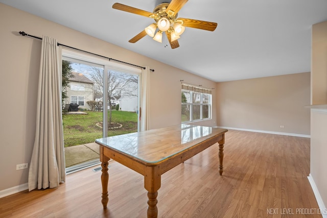 dining area featuring light wood finished floors, a ceiling fan, visible vents, and baseboards