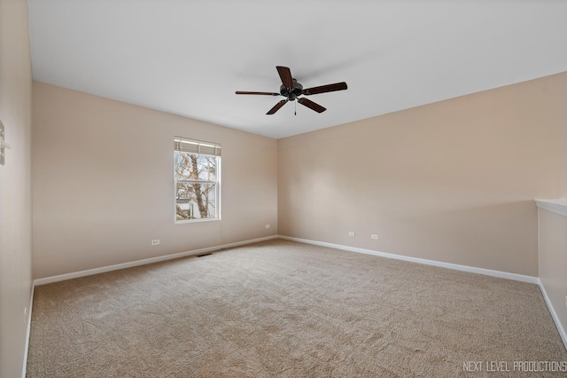 unfurnished room featuring carpet floors, ceiling fan, and baseboards