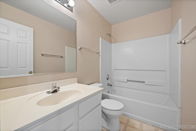 bathroom featuring toilet, tile patterned floors, shower / tub combination, and vanity