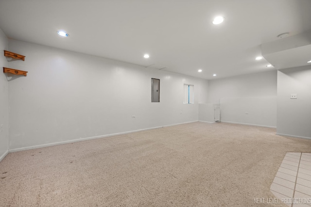 interior space with baseboards, recessed lighting, light carpet, and electric panel