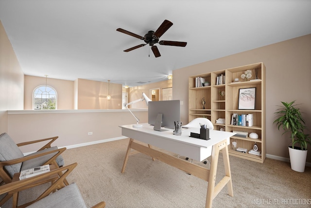office area featuring ceiling fan, light carpet, and baseboards
