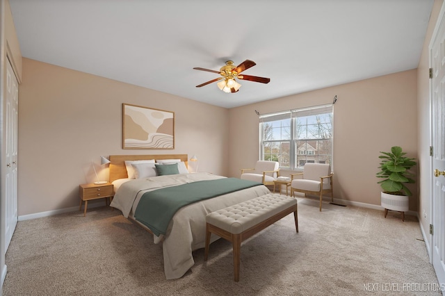 bedroom featuring ceiling fan, a closet, light carpet, and baseboards