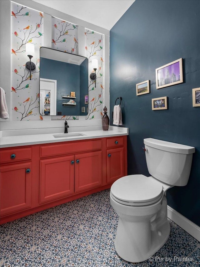 623 Oakton St, Evanston, IL 60202 - half bathroom with baseboards, toilet, vanity, and tile patterned floors
