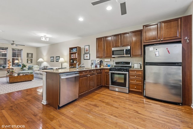 507 Grove Ln Unit H, Forest Park, IL 60130 - kitchen with a sink, light wood finished floors, stainless steel appliances, a ceiling fan, and a peninsula