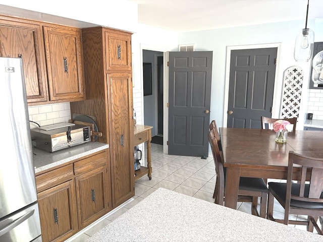 dining space with visible vents, a toaster, and light tile patterned floors