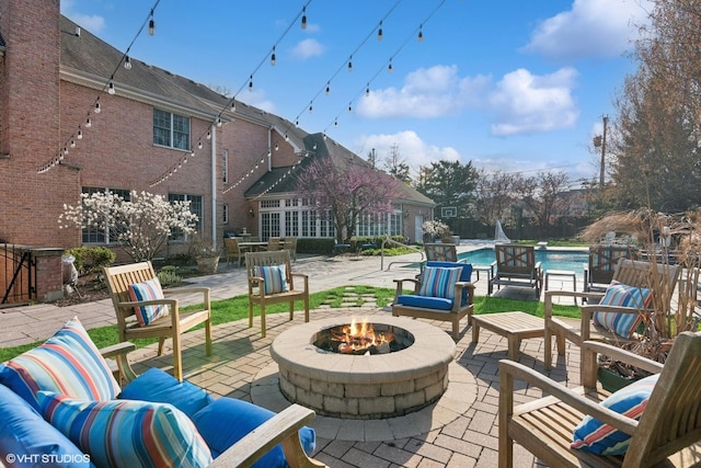 view of patio / terrace with a fenced in pool and a fire pit