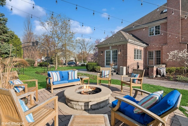 view of patio / terrace featuring an outdoor living space with a fire pit