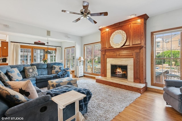 living area with plenty of natural light, visible vents, ceiling fan, and light wood-style floors