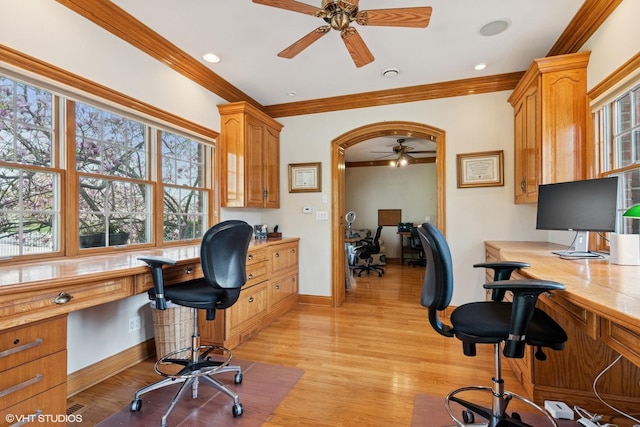 office space featuring built in desk, ceiling fan, ornamental molding, and plenty of natural light