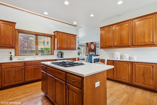 kitchen with recessed lighting, a sink, stainless steel gas stovetop, light wood-style floors, and light countertops