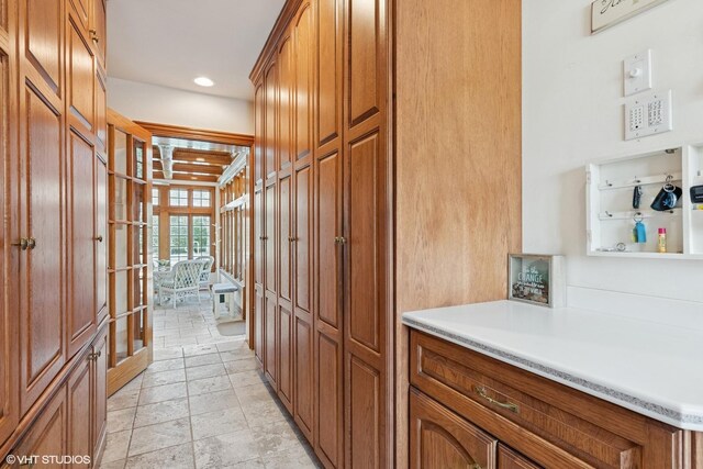 hall featuring stone finish flooring