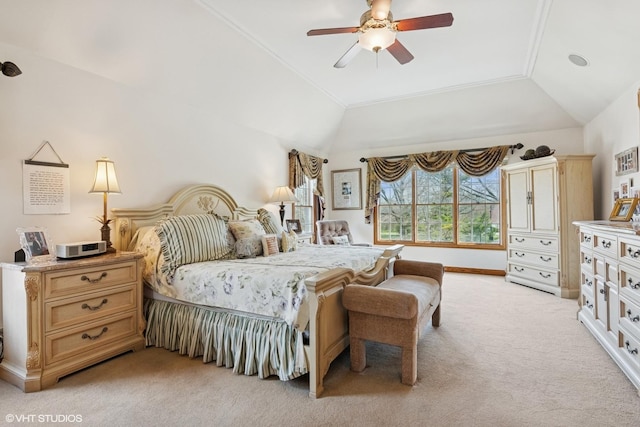 bedroom featuring ceiling fan, vaulted ceiling, and light carpet