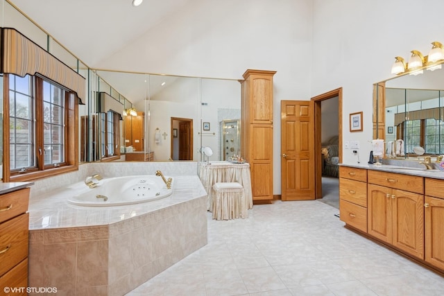 full bathroom featuring connected bathroom, a shower stall, a tub with jets, vanity, and high vaulted ceiling