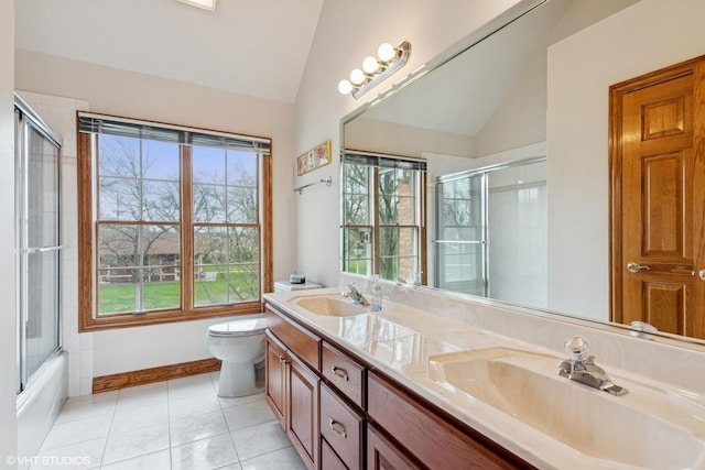 full bathroom featuring tile patterned floors, toilet, vaulted ceiling, and a sink