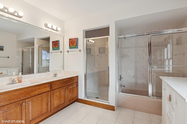 full bath featuring a sink, tile patterned flooring, double vanity, and combined bath / shower with glass door