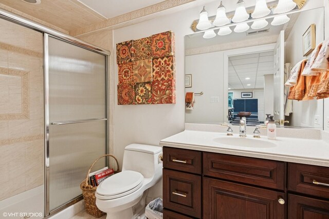 full bathroom featuring toilet, visible vents, a shower stall, and vanity