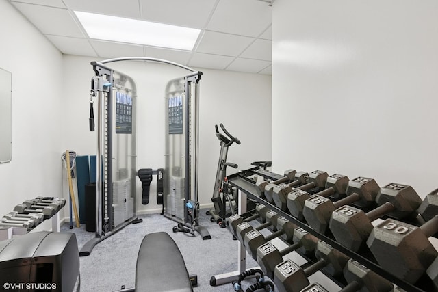 exercise room with a drop ceiling and carpet