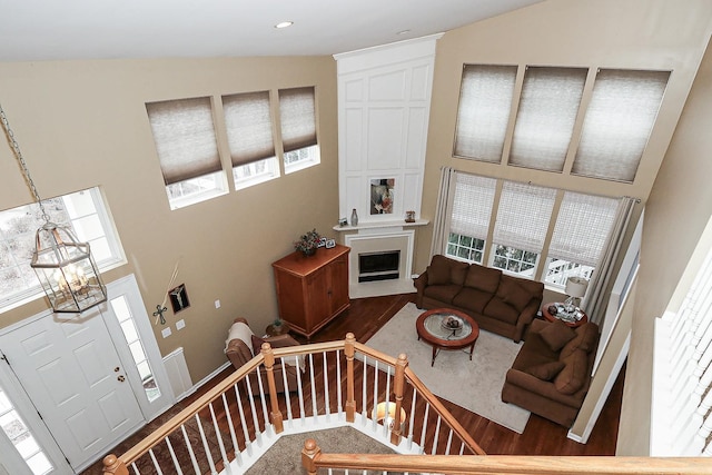 living area with recessed lighting, a fireplace, and wood finished floors